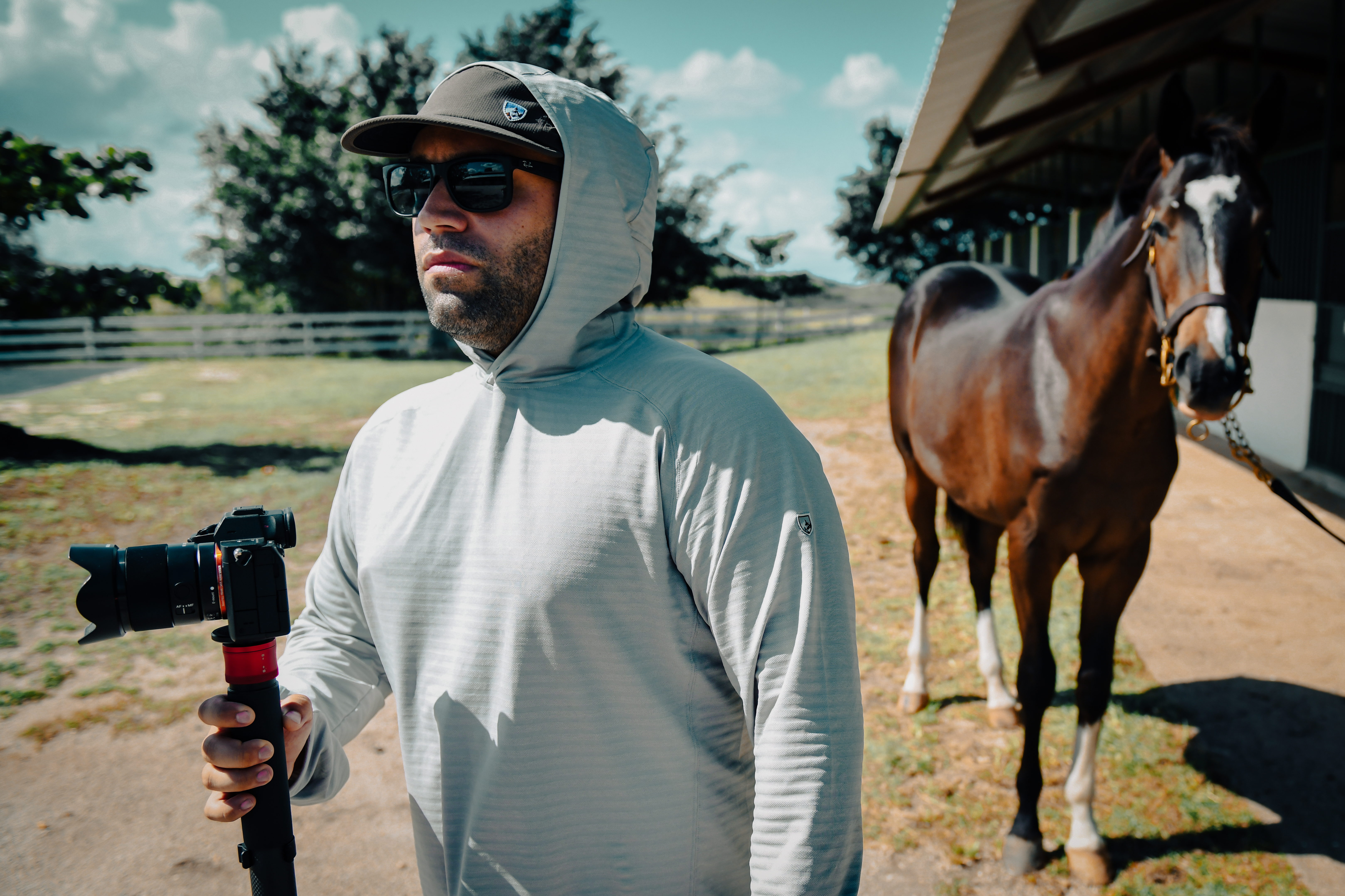 Filmmaker with horse at racetrack